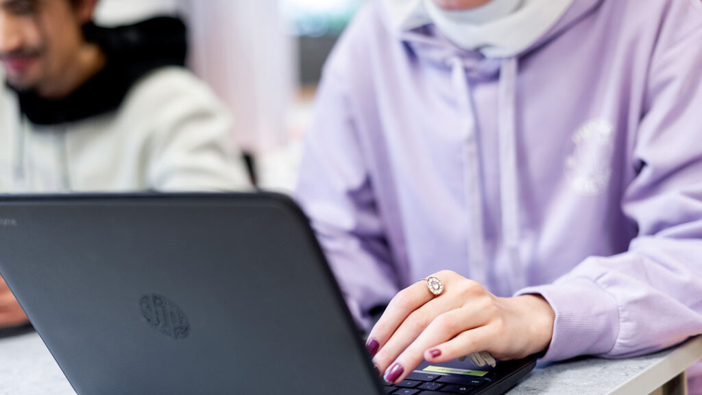 Närbild på kvinna som arbetar med dator.